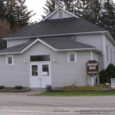 A modernized community hall, with newly finished grey siding