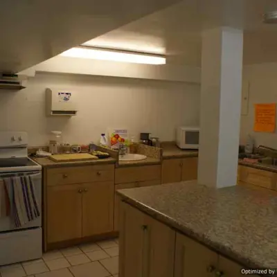 A dimly lit kitchen, with old wooden finish