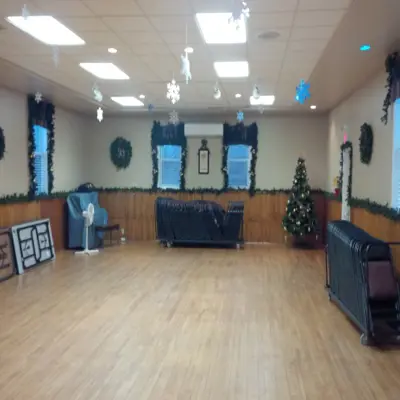 Paper snowflakes hang from a festive interior hall room