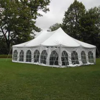 A pop-up tent placed on a lush green yard