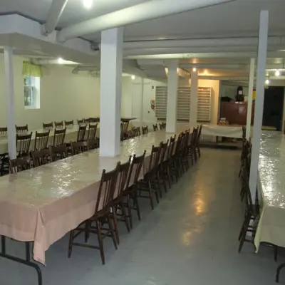 Rows of seating are setup within a community hall