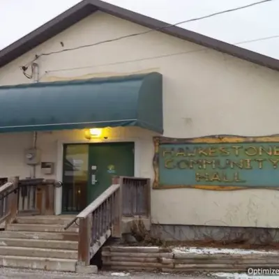 Exterior of an older community building with an awning above the entrance